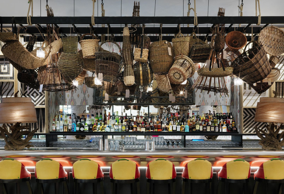 A collection of 52 wicket baskets hang above the bar at The Whitby Hotel in New York